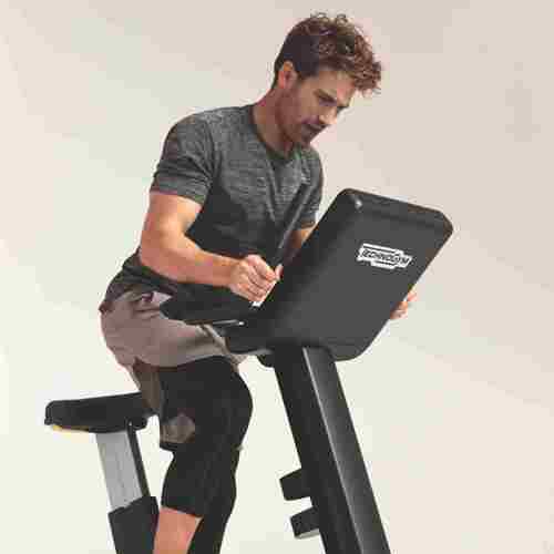 Man on Exercise Bike in Gym