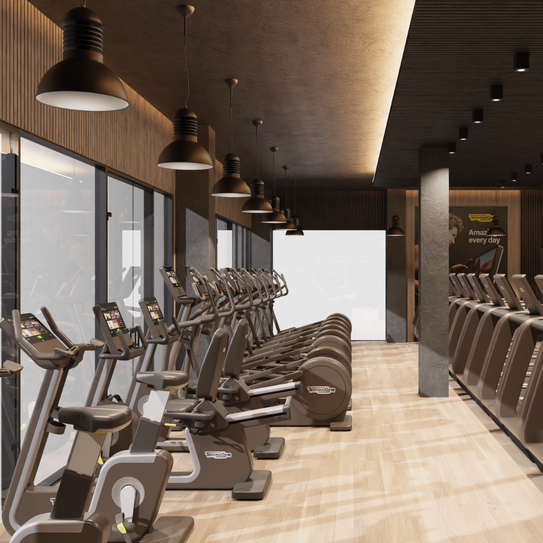 A gym room featuring various exercise machines and a row of large windows allowing natural light to enter.
