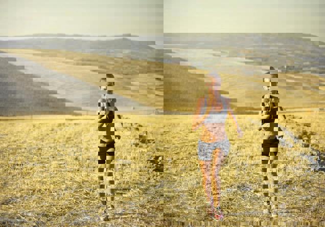 sportwoman running along hill