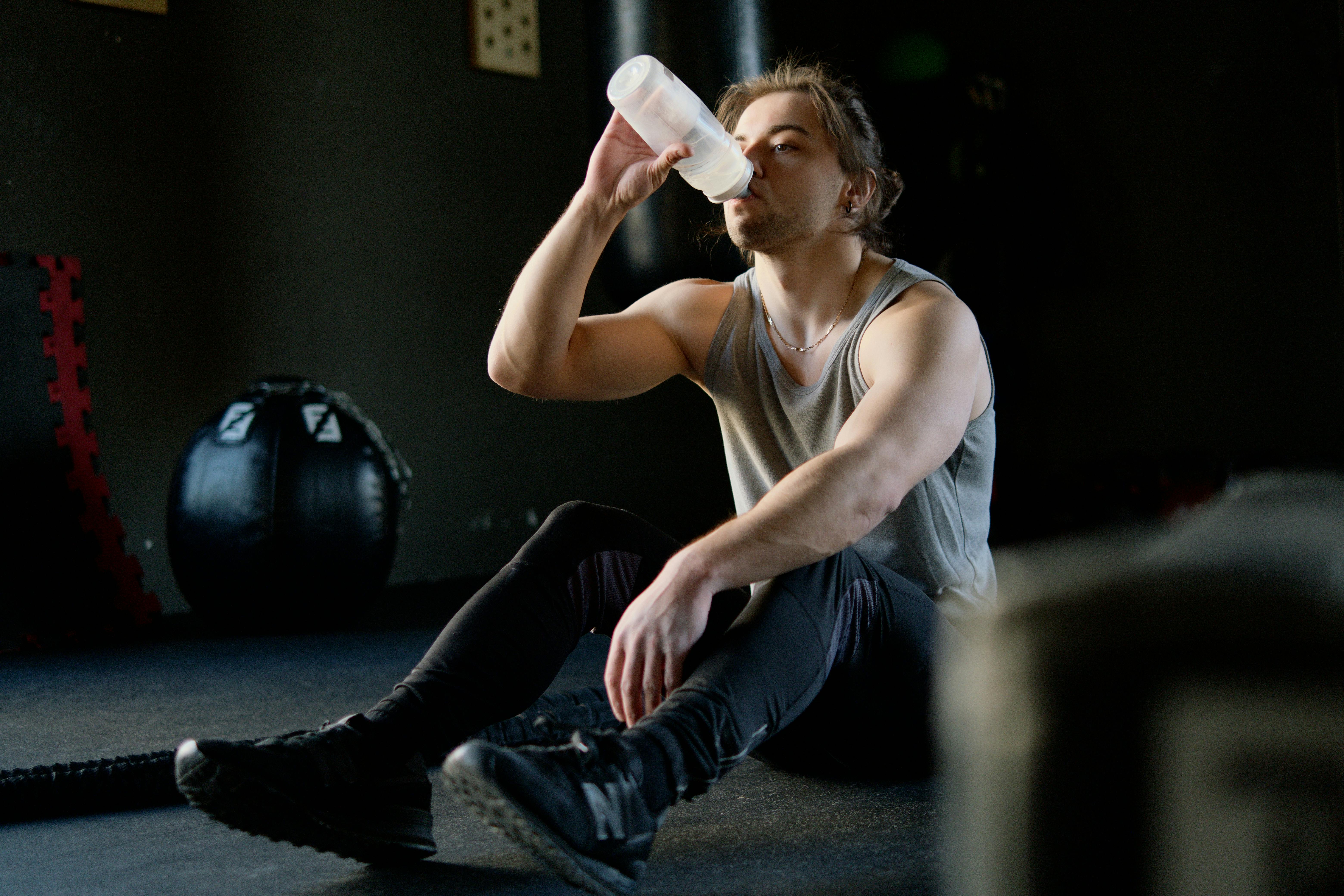 Man sitting on the floor drinking water