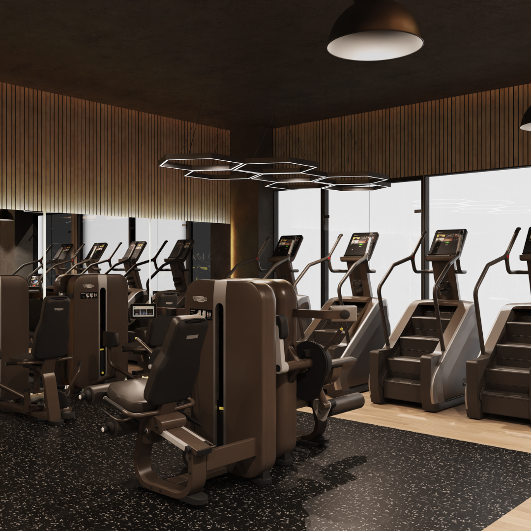 A well-equipped gym room with exercise machines and a large window that brightens the space.