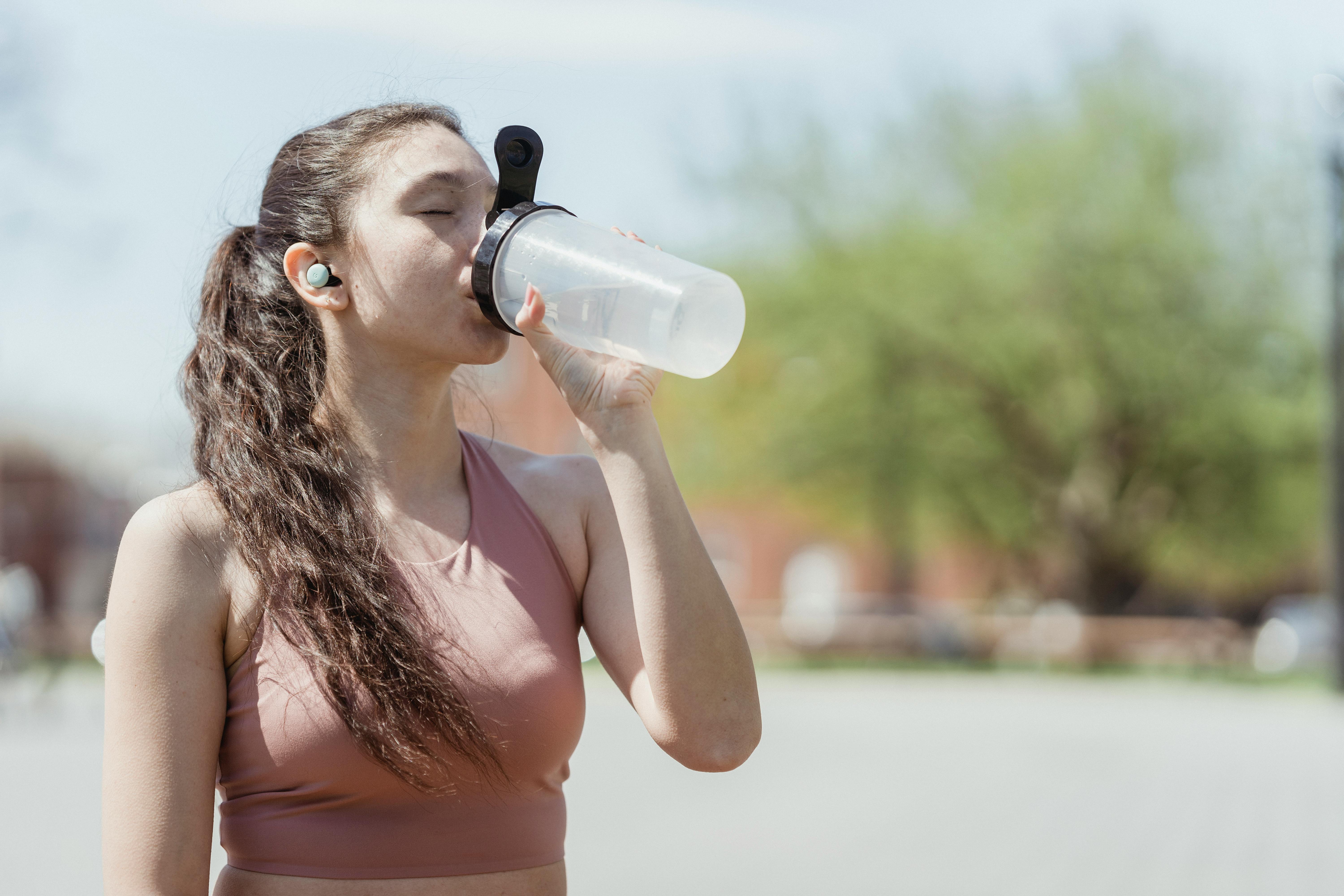 Woman in sportswear drinking water