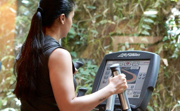 Woman using a cross trainer machine