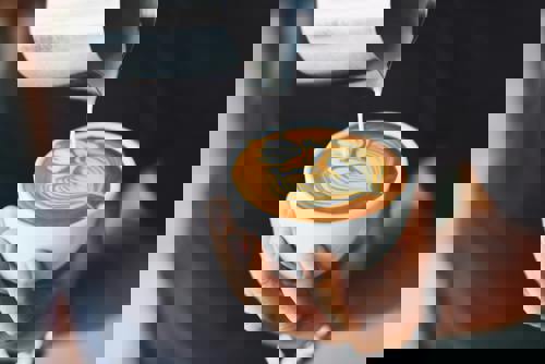 Person performing coffee art